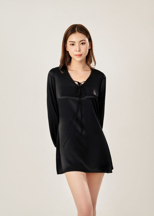 Detail view of Cheries Apparel midi shirt dress in black, featuring puffed long sleeves, a V-neckline with double-needle stitching, and hidden pockets