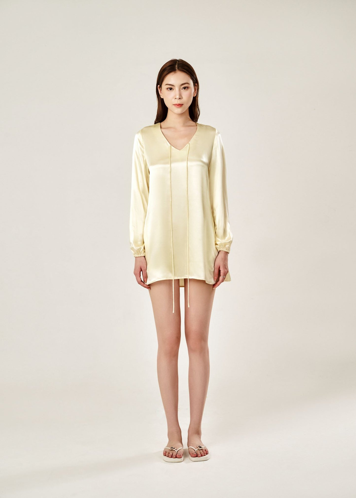 Front view of Cheries Apparel midi shirt dress in beige, featuring puffed long sleeves, a V-neckline with double-needle stitching, and hidden pockets