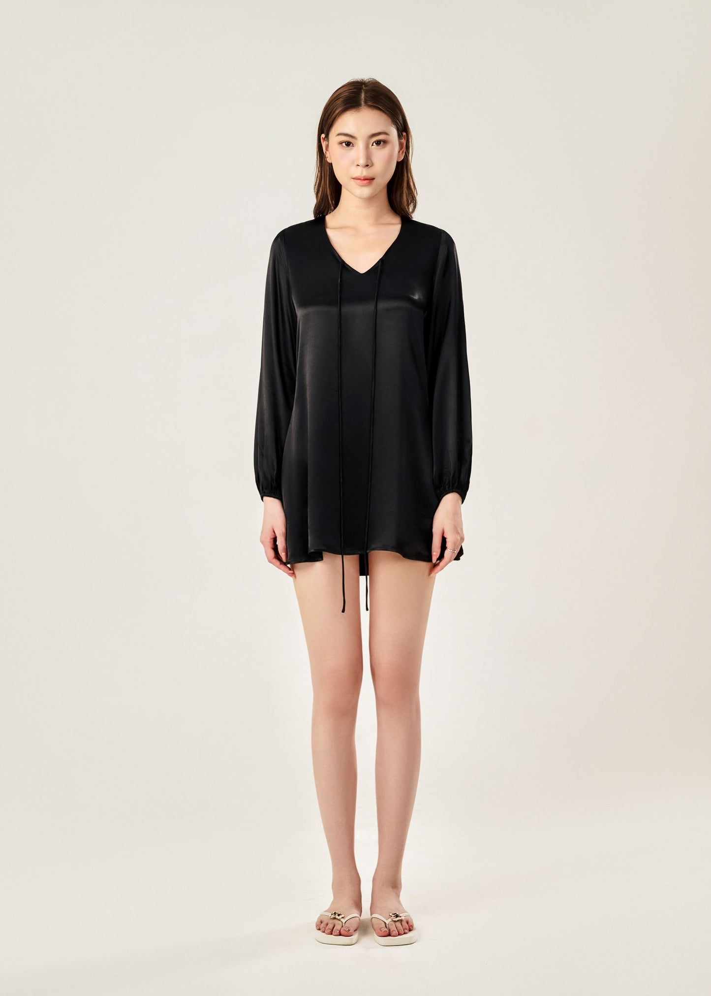 Front view of Cheries Apparel midi shirt dress in black, featuring puffed long sleeves, a V-neckline with double-needle stitching, and hidden pockets