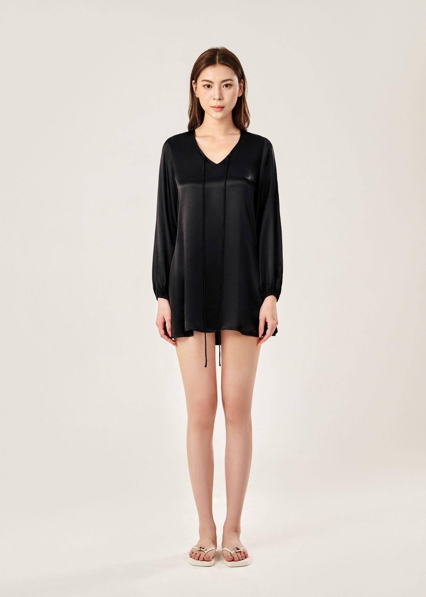 Front view of Cheries Apparel midi shirt dress in black, featuring puffed long sleeves, a V-neckline with double-needle stitching, and hidden pockets